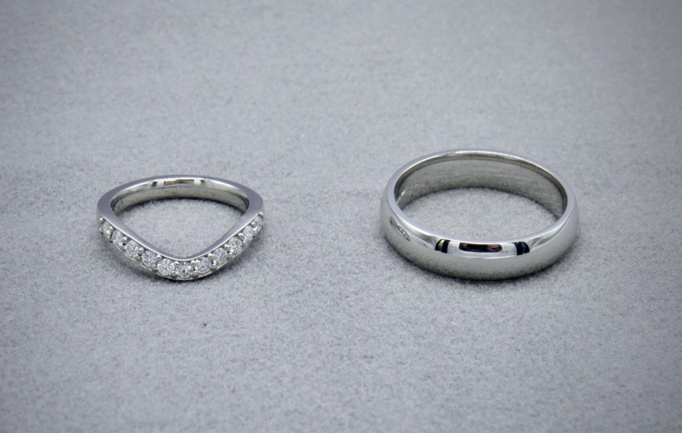 diamond curved wedding band in platinum and plain platinum wedding band