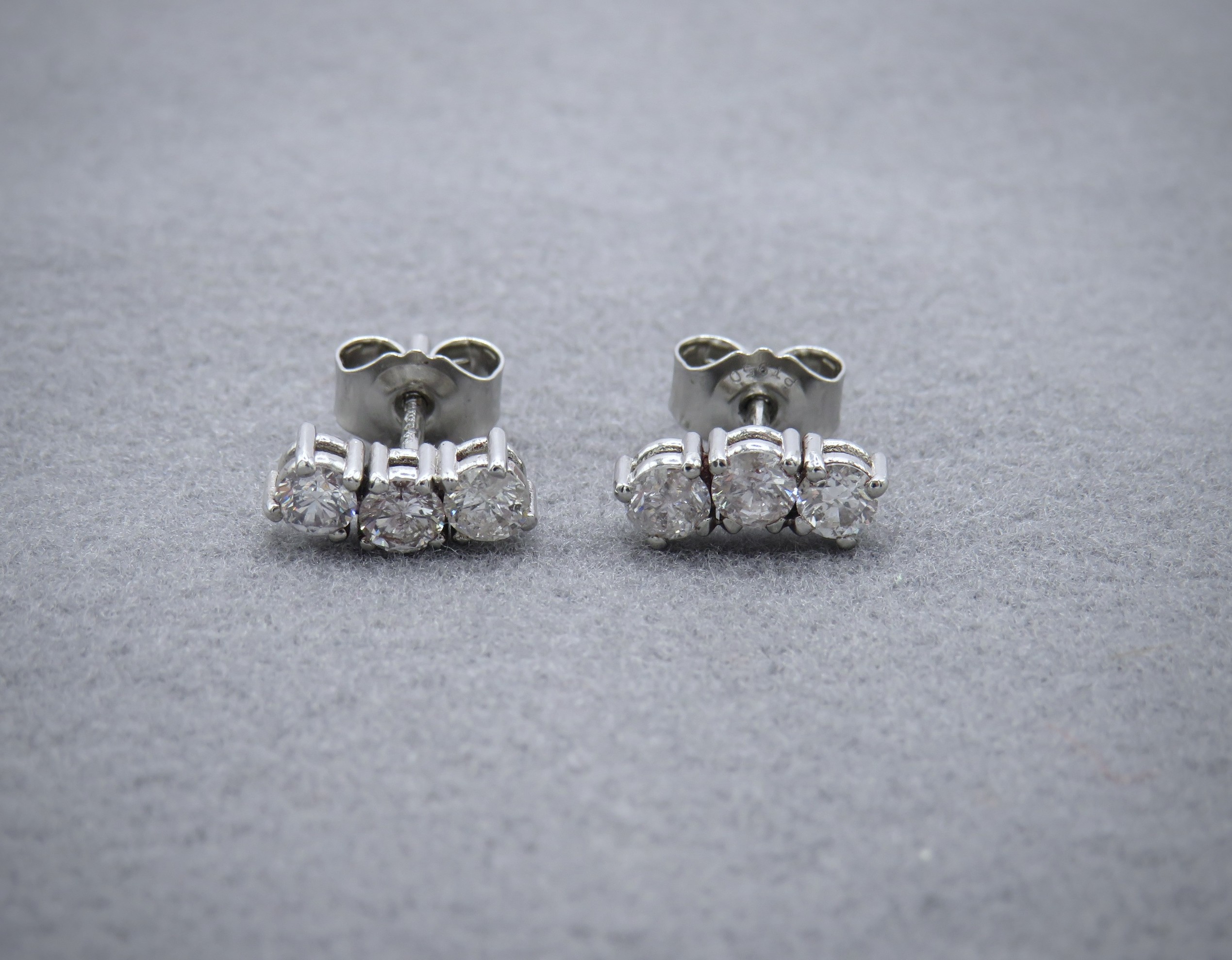 Three Round Brilliant Diamonds on a curved earring