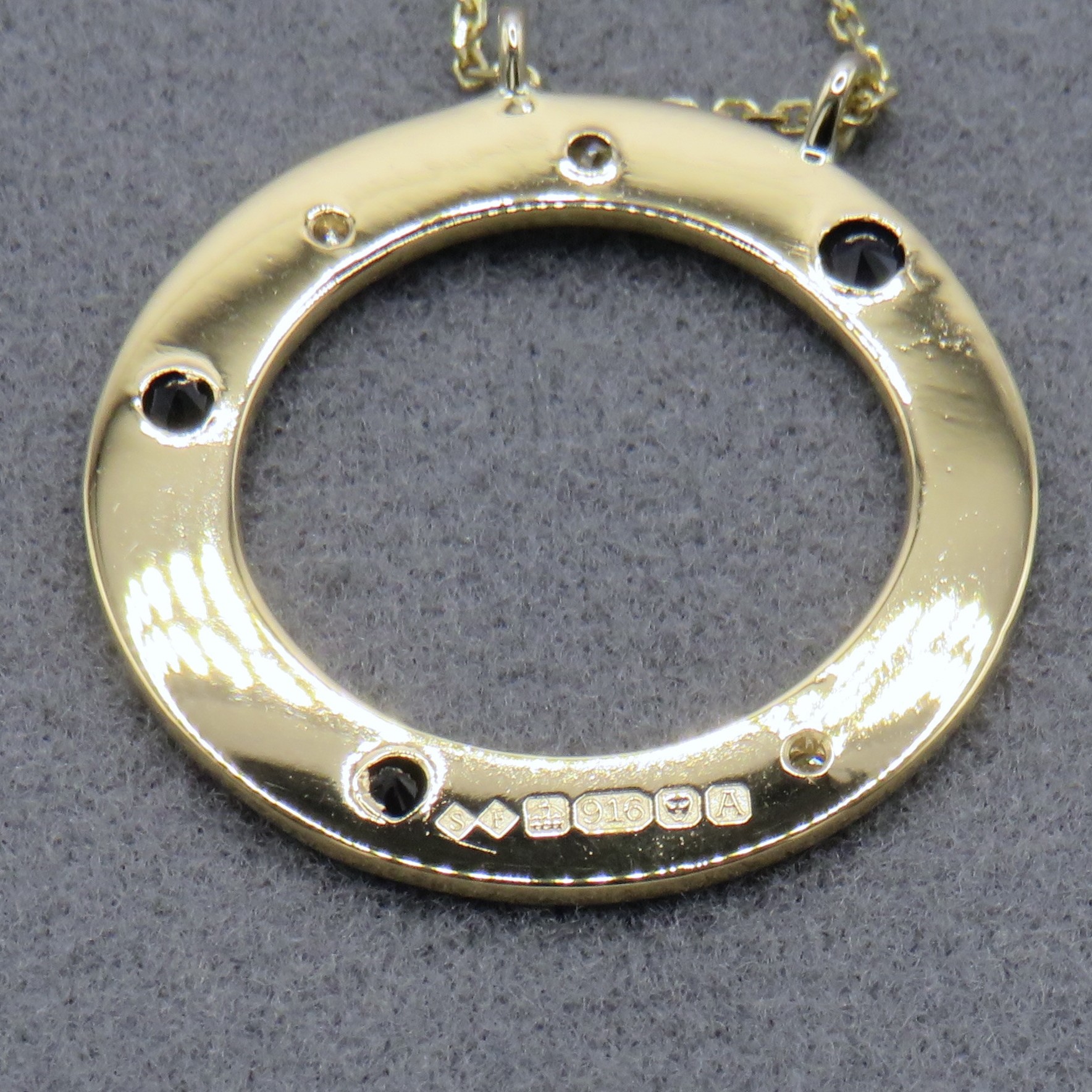 Yellow gold disc with hallmarks